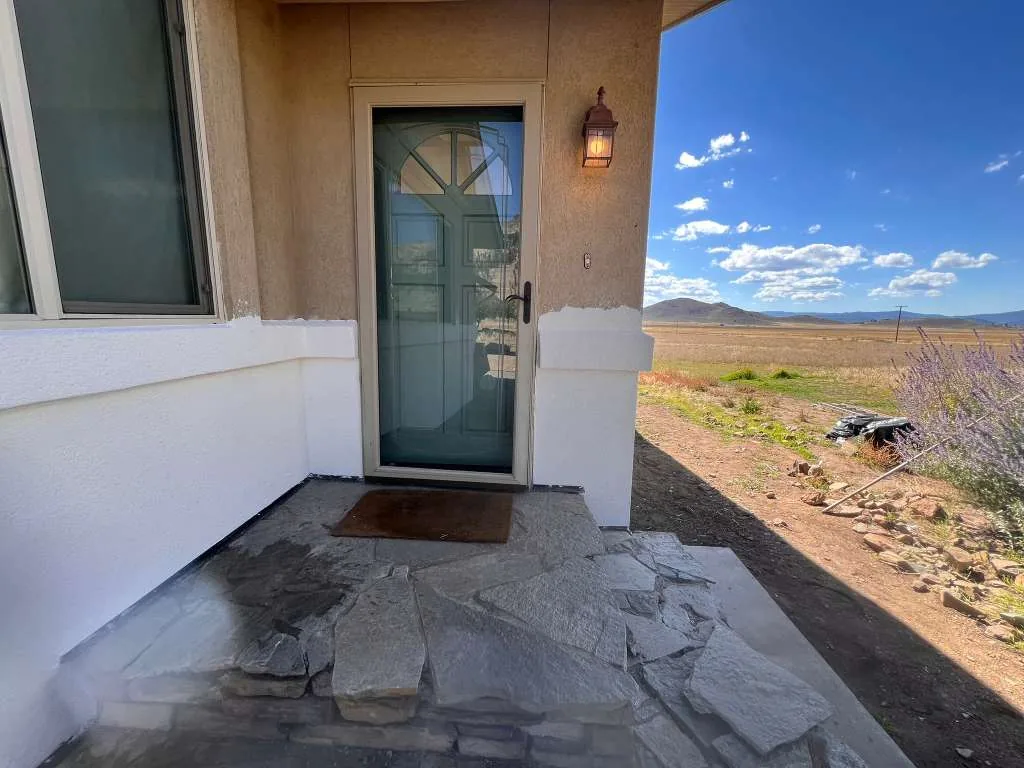Freshly recoated white stucco entry wall on a desert home with mountain views near Reno, NV