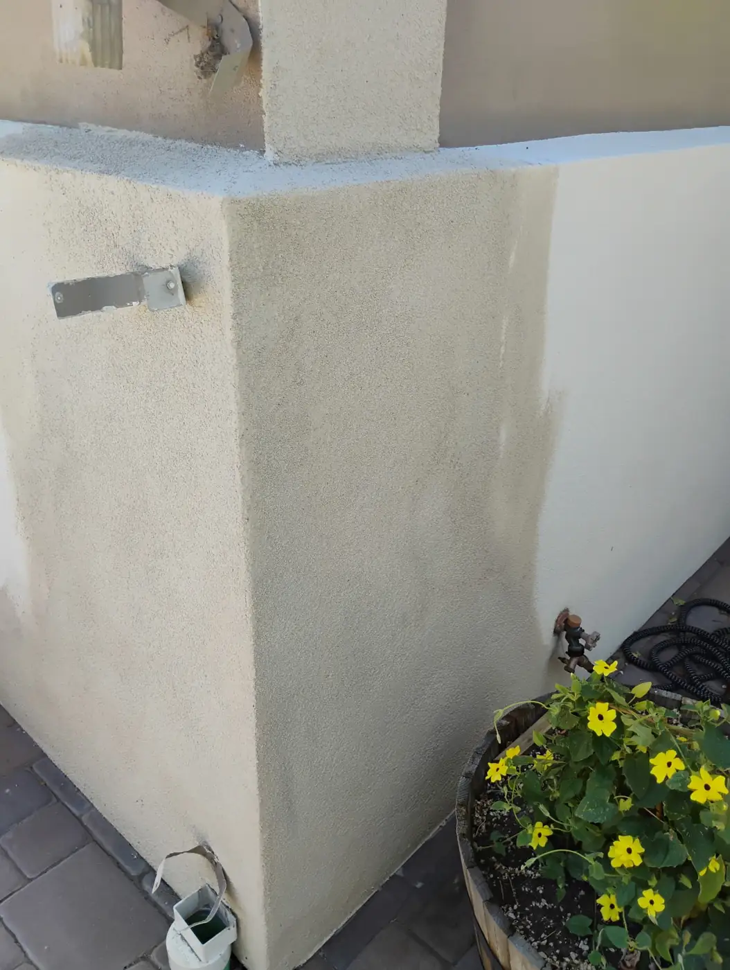 Smooth recoated stucco wall corner with garden planter in Reno, NV